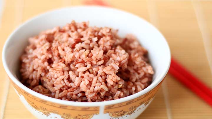 Steamed red rice on white bowl